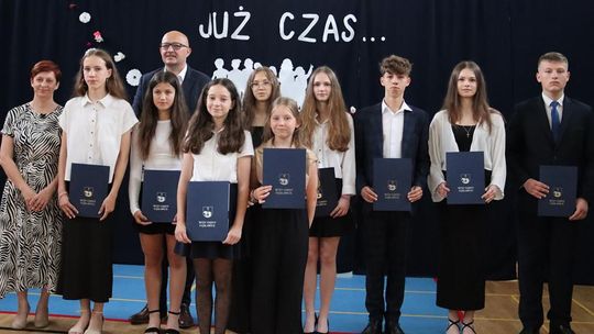 Zdjęcie przedstawia uczniów nagrodzonych Stypendiami Wójta Gminy Fajsławice podczas uroczystości zakończenia roku szkolnego w dniu 27 czerwca 2025r. w Szkole Podstawowej im. bł. Jana Pawła II w Siedliskach Drugich